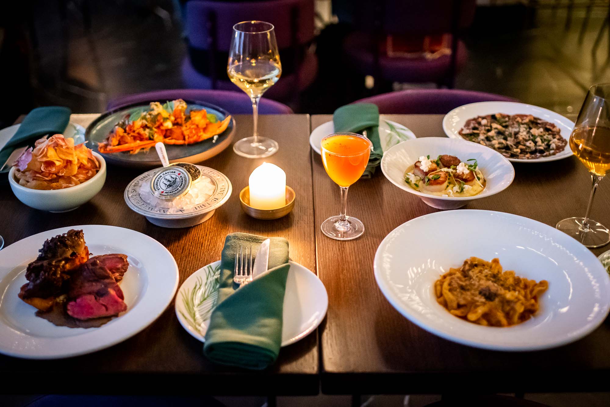 Spread of dishes in candlelight