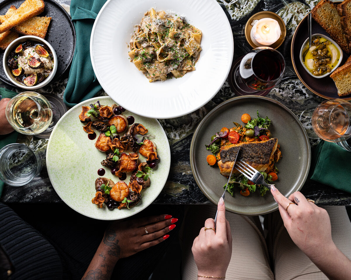 two guests enjoying several plates at the table