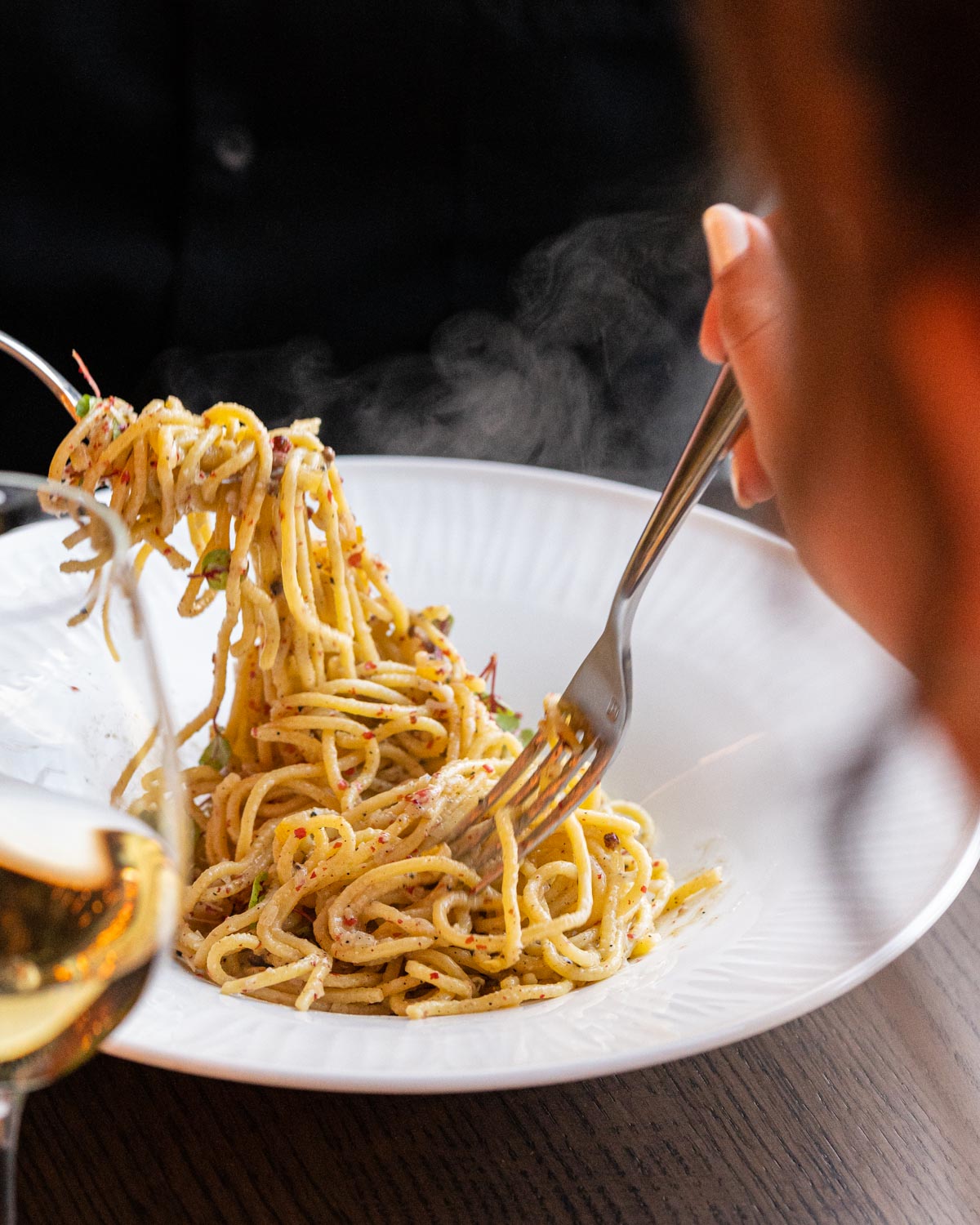 forks swirling long pasta noodles